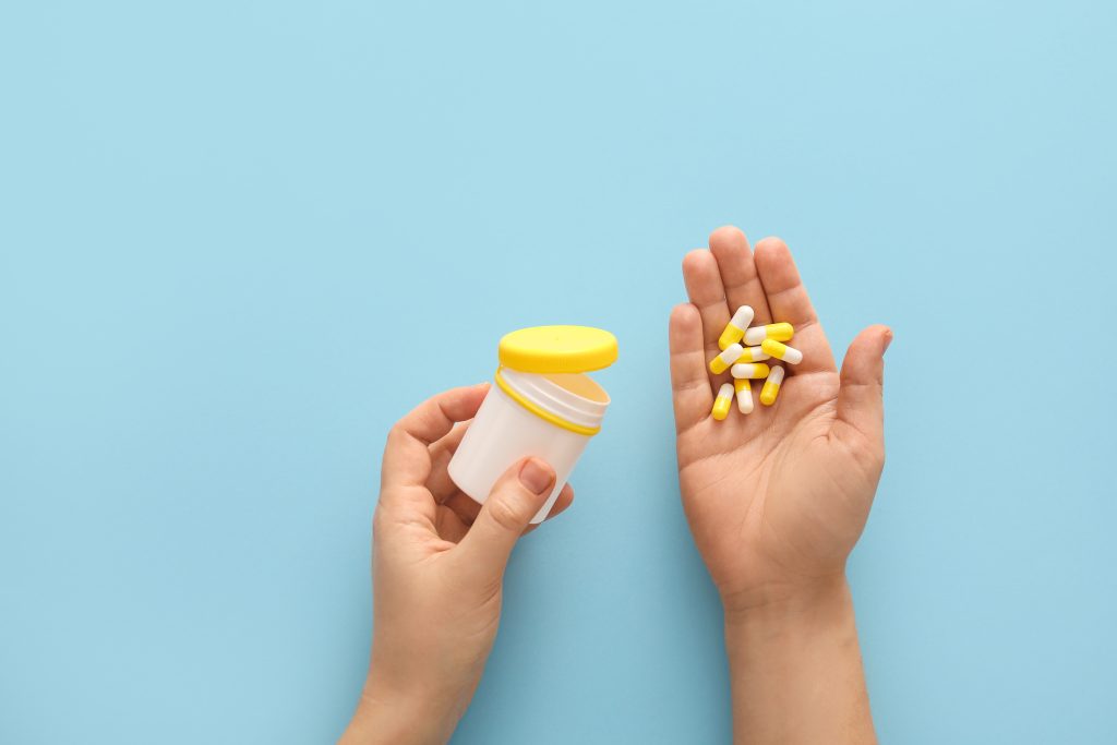 Woman holding vitamins