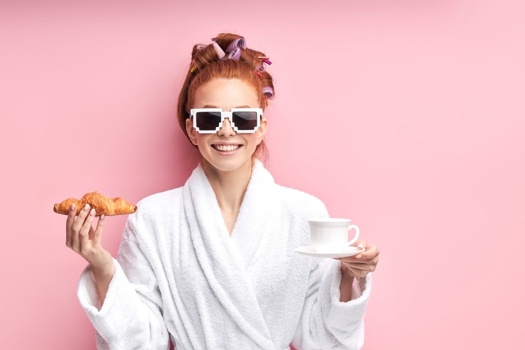 https://www.123rf.com/photo_132268070_caucasian-girl-after-shower-enjoying-cup-of-tea-with-croissant-isolated-over-pink-background.html